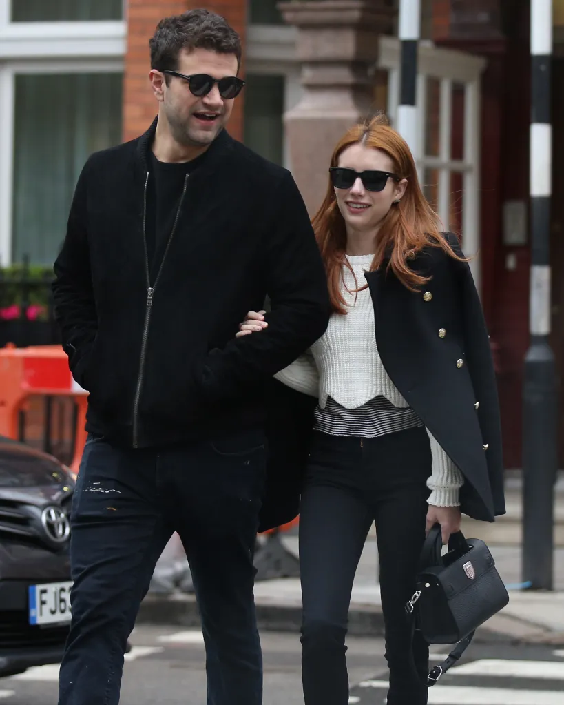 Emma Roberts and Christopher Hines walking arm-in-arm in London.