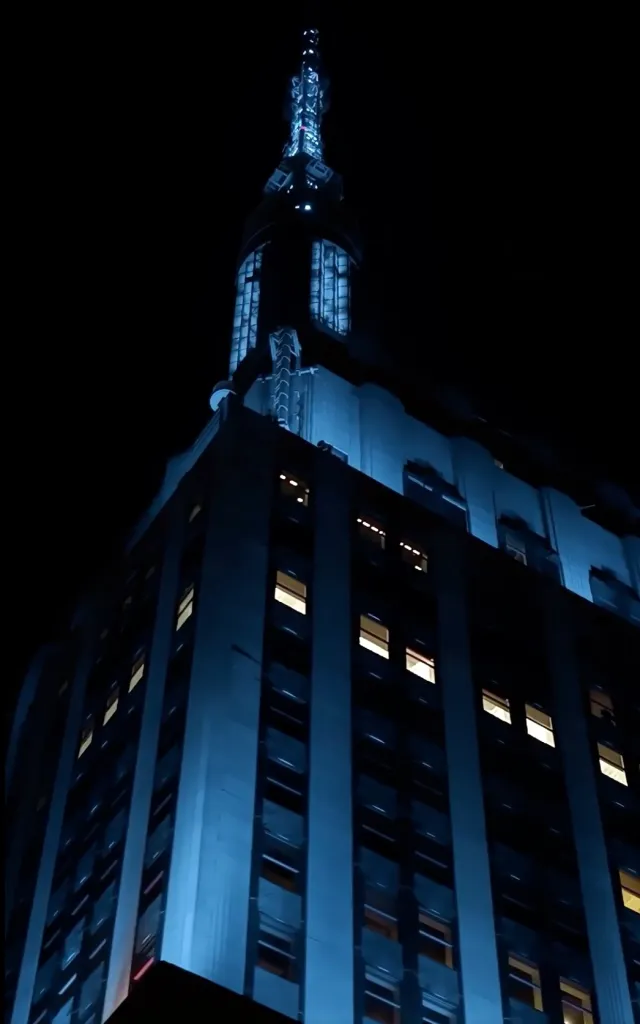 The Empire State Building lit in blue at night.
