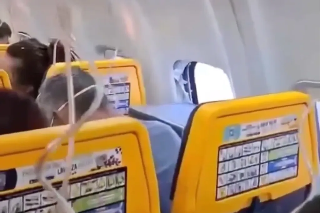 A Ryanair cabin with a shattered window and visible engine debris inside.