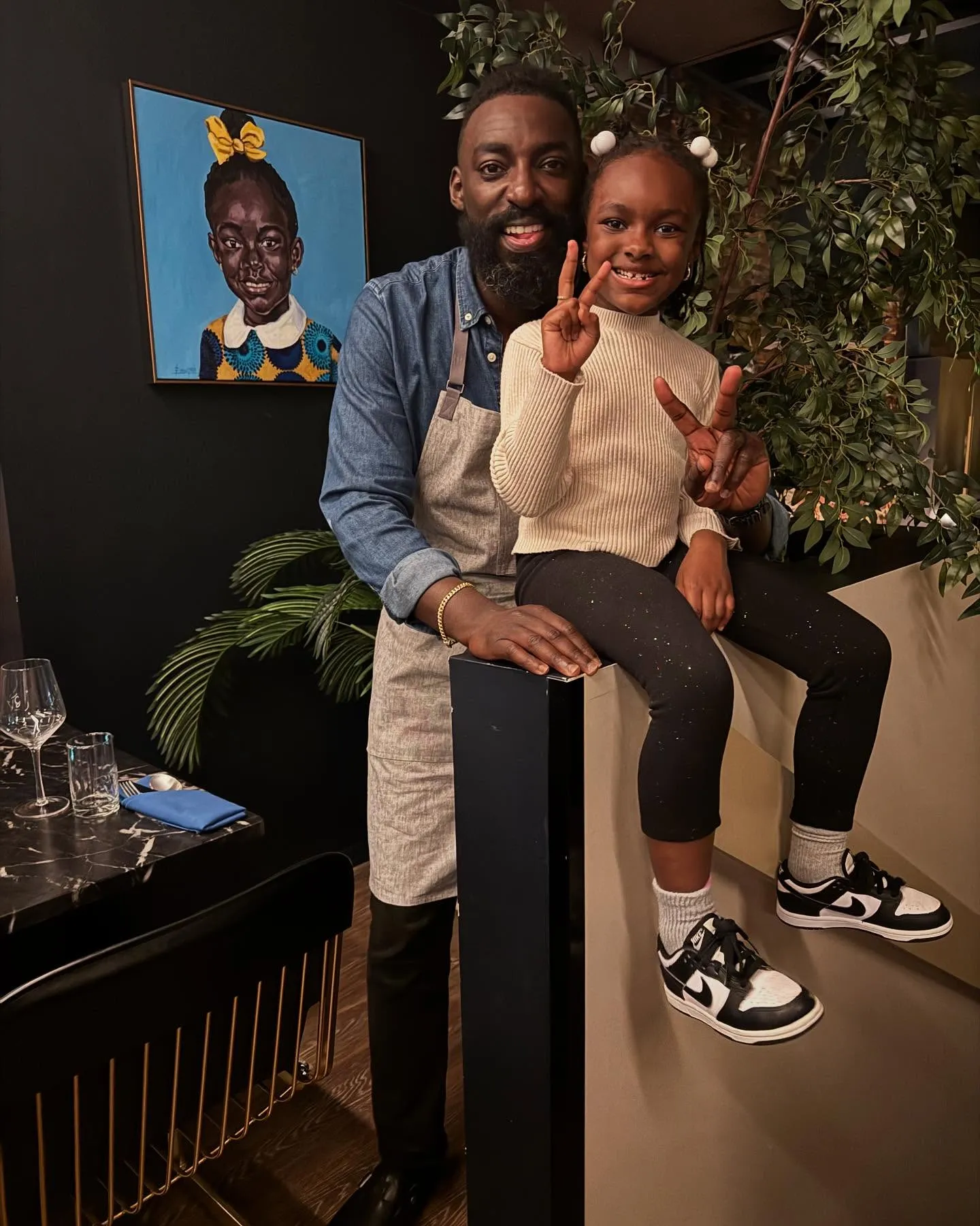 Eric Adjepong and his daughter posing together.