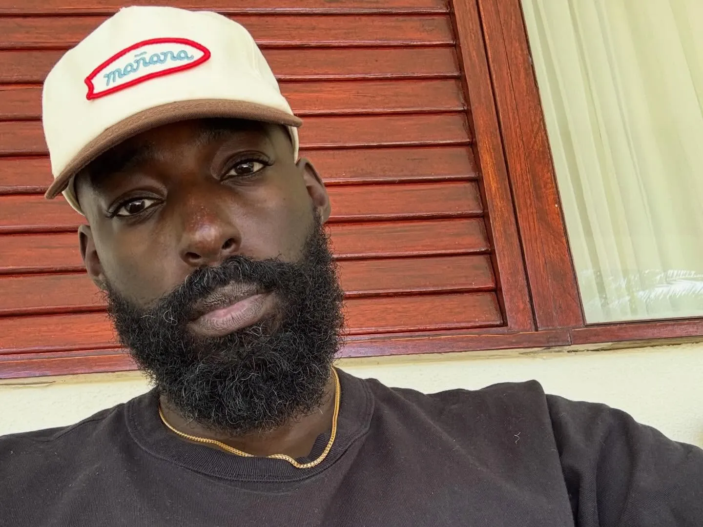 Eric Adjepong wearing a "mañana" cap.