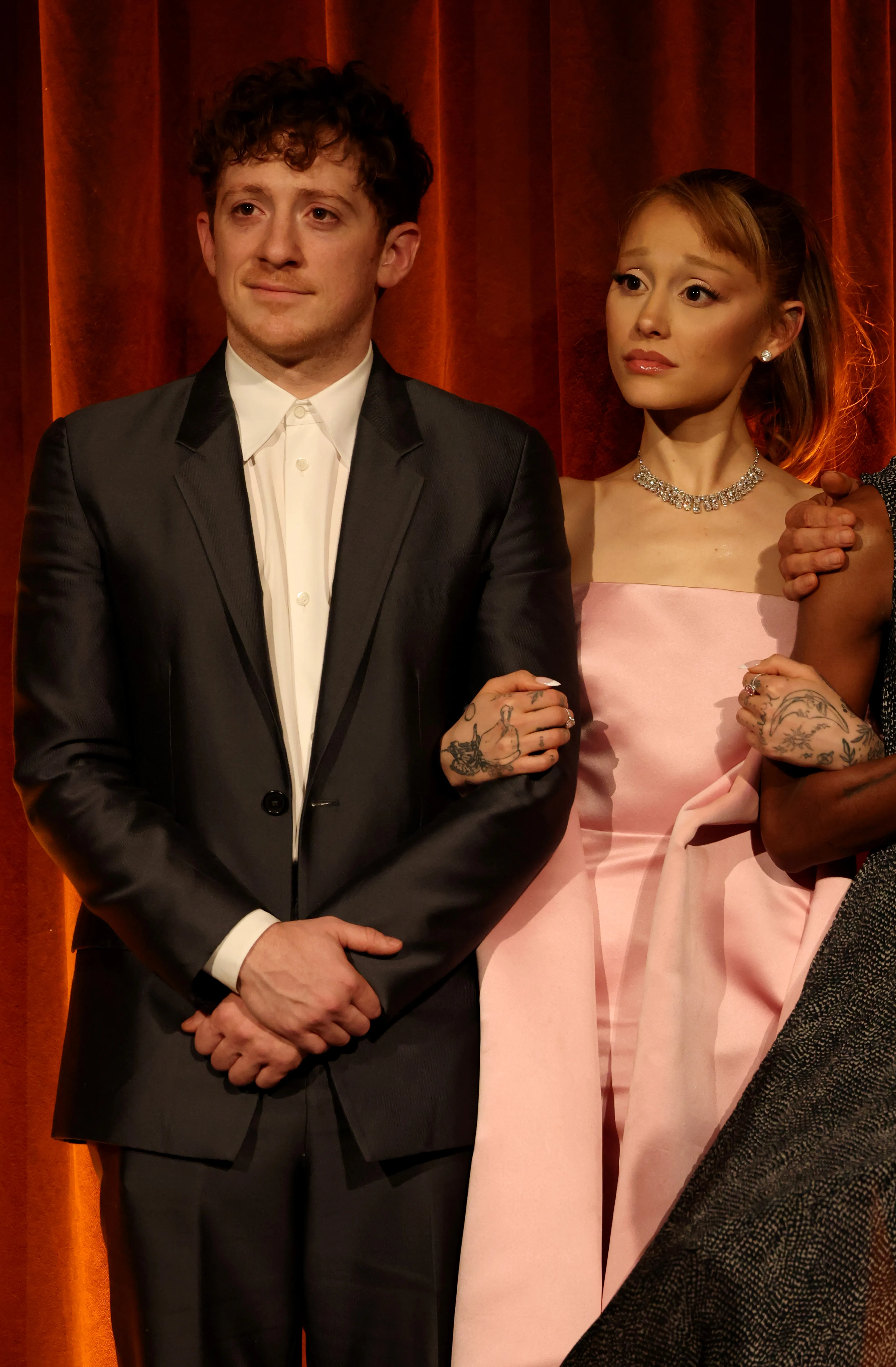 Ethan Slater and Ariana Grande accept the Best Film Award for "Wicked" onstage.