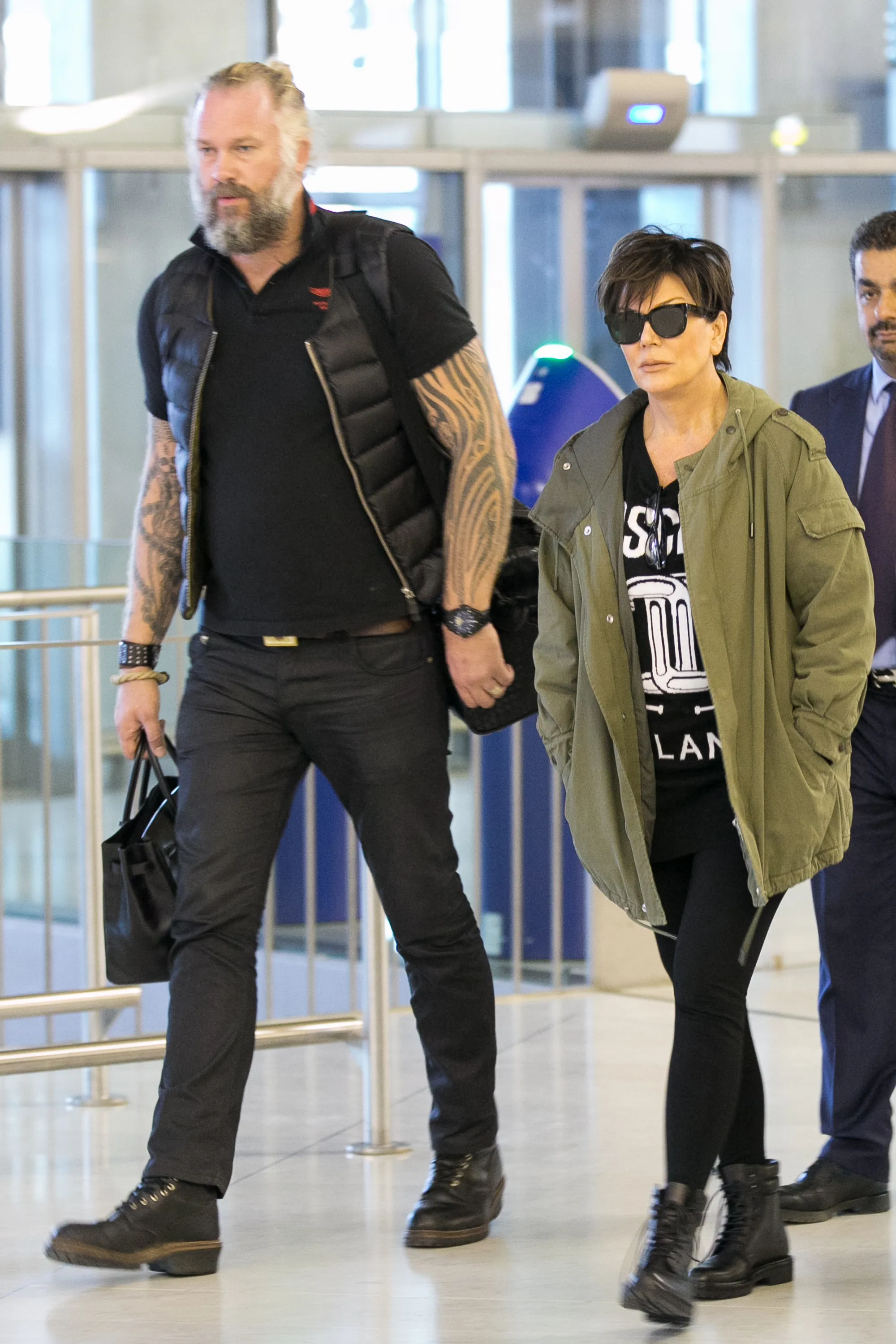 Kris Jenner walking with a celebrity bodyguard.