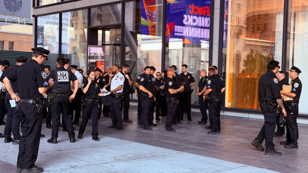 NYPD officers hold a security meeting outside Madison Square Garden.
