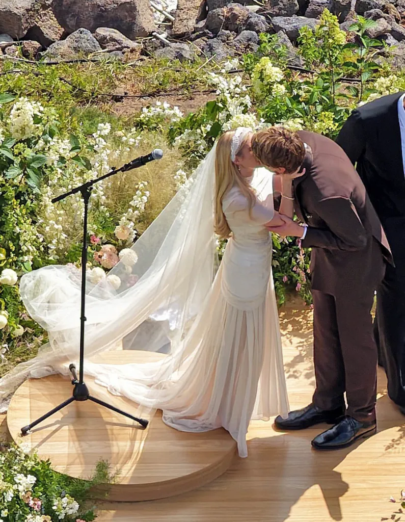 Emma Roberts and Cody John share a kiss at their wedding ceremony.