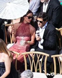 Ashley Benson and Brandon Davis seated at a wedding.