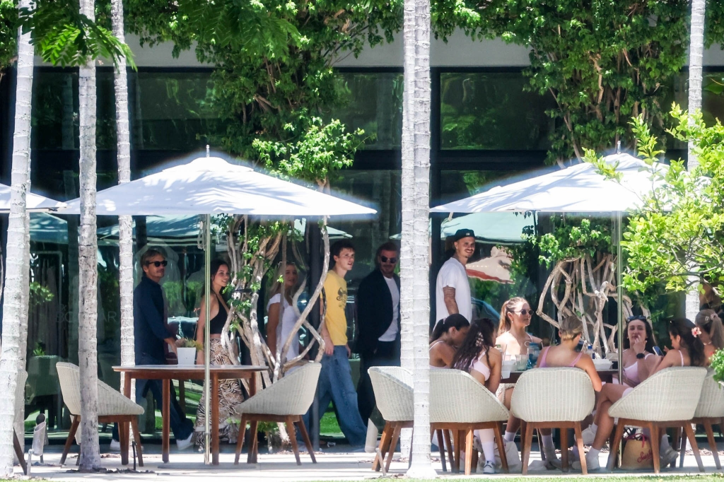David and Victoria Beckham celebrating Harper's 15th birthday with family and friends at an outdoor restaurant.