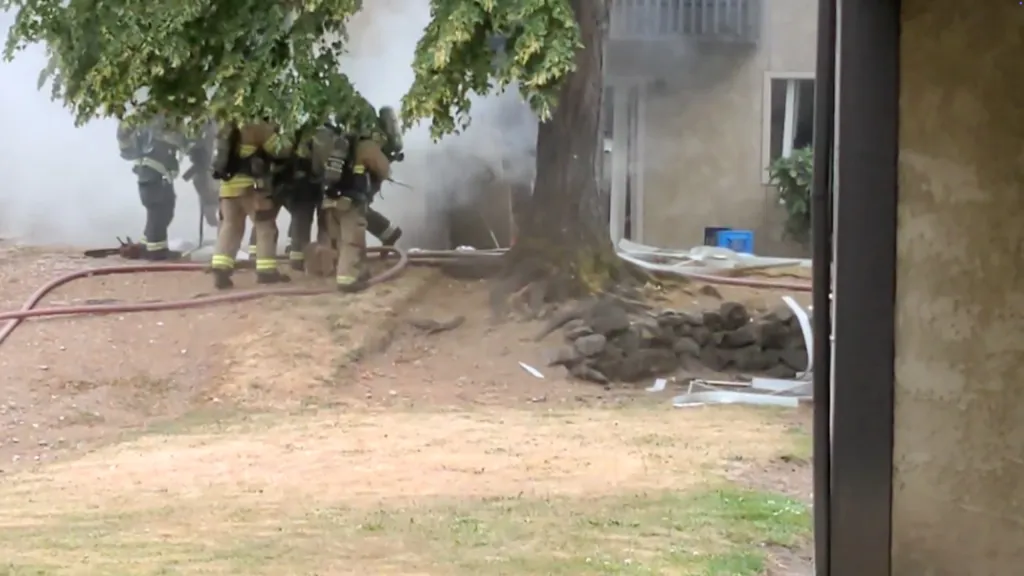 Fire alarms sounded after a resident pulled the alarm, prompting crews to evacuate buildings as a precaution.