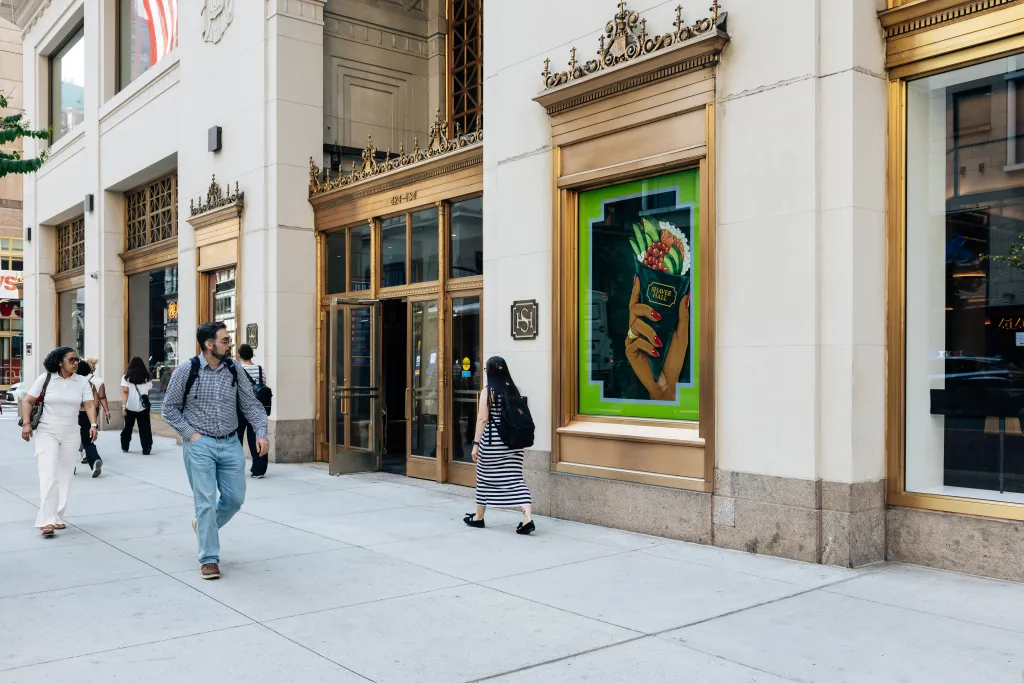 Exterior of Shaver Hall in Manhattan with pedestrians on the sidewalk.