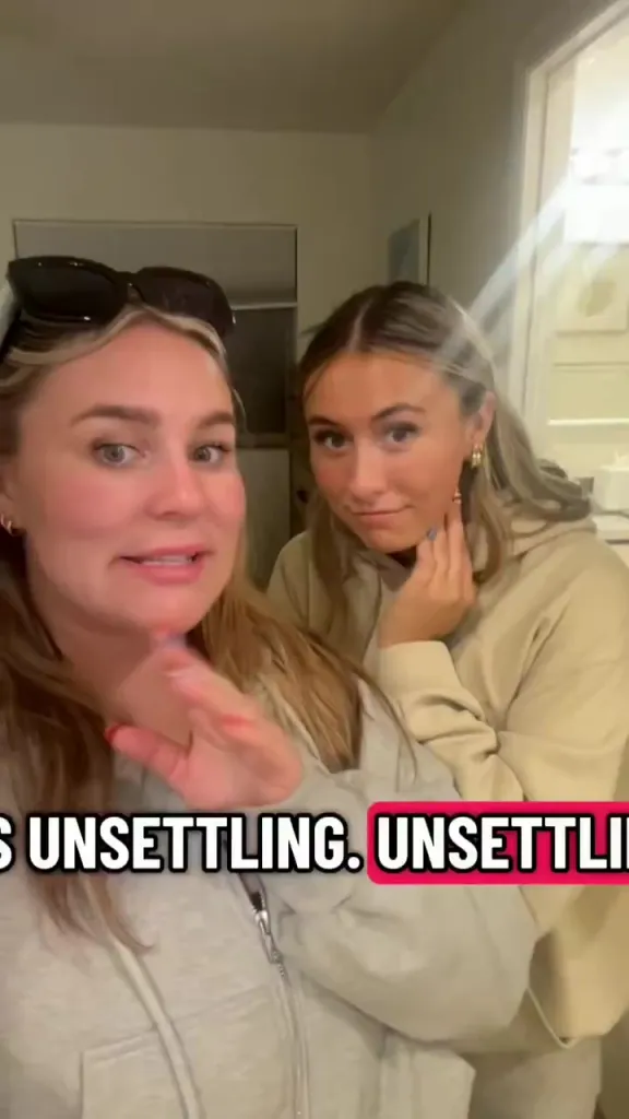 Two young women appear surprised and uncomfortable in a video with the text "UNSETTLING. UNSETTLING" displayed over it.