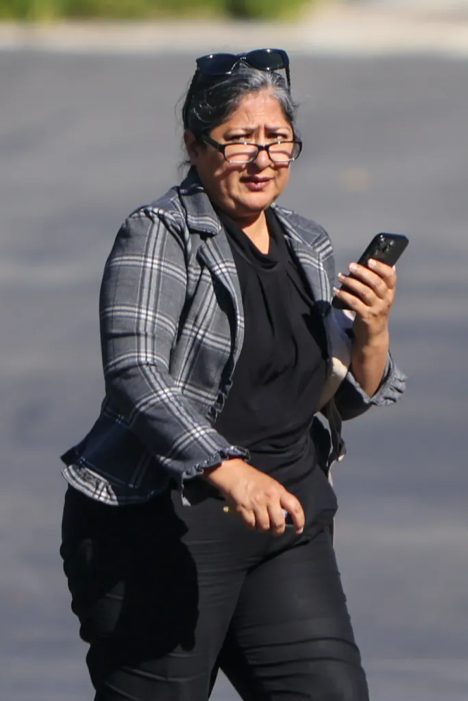 Farrah Khan walking in Orange County, holding a phone.