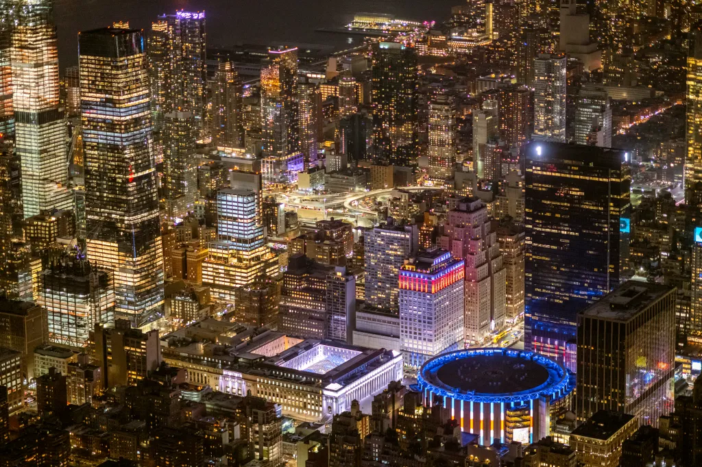 Aerial view of Moynihan Station and Madison Square Garden at night in New York City.