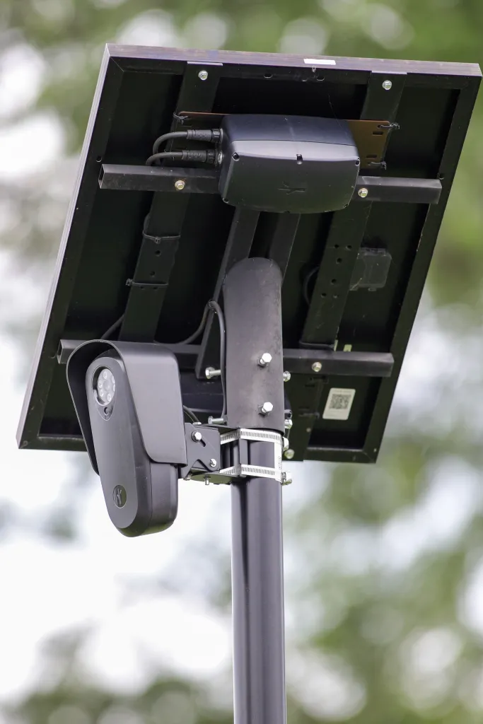 Flock Safety automated license plate recognition camera mounted on a pole with a solar panel.