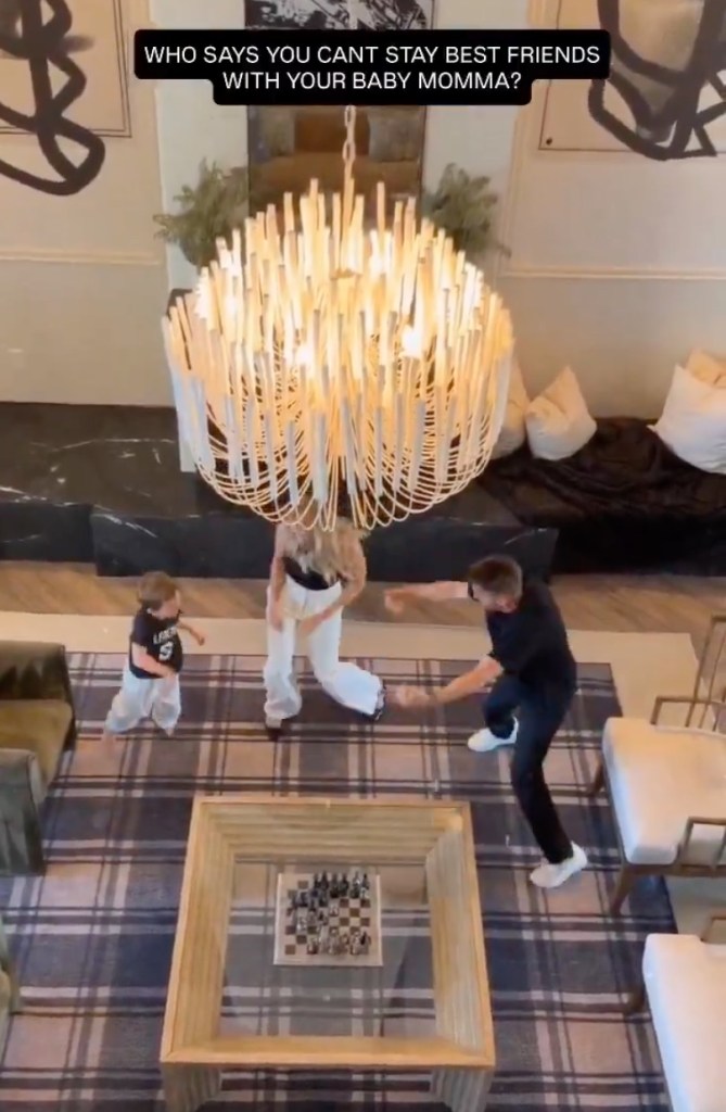 Frankie Muniz, his wife Paige Price, and their son dance under a chandelier in a living room.
