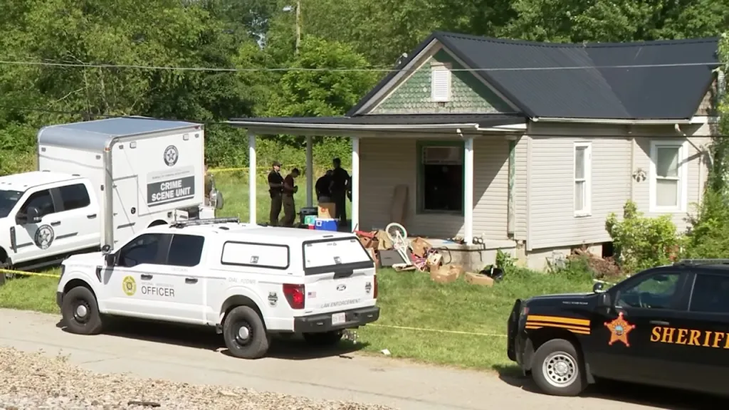 exterior image of the Vinton County, Ohio, home where authorities allege 16 kids were kept in horrific conditions, with police vehicles seen parked out front of the house