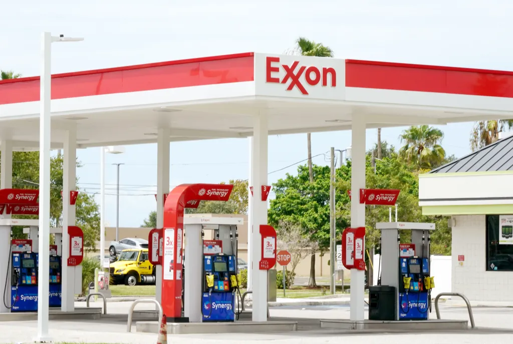 An Exxon gas station in Clearwater, Florida, featuring red and white branding and "Synergy" fuel pumps.