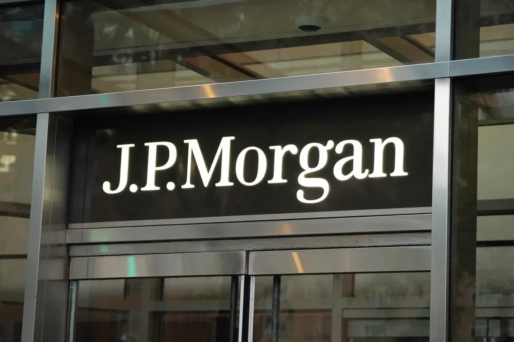 The illuminated J.P. Morgan sign above an entrance in New York City.