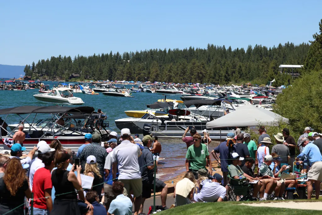 Crowds of people and numerous boats line the 17th and 18th fairways at the American National Golf championships at The Edgewood, Lake Tahoe, CA.
