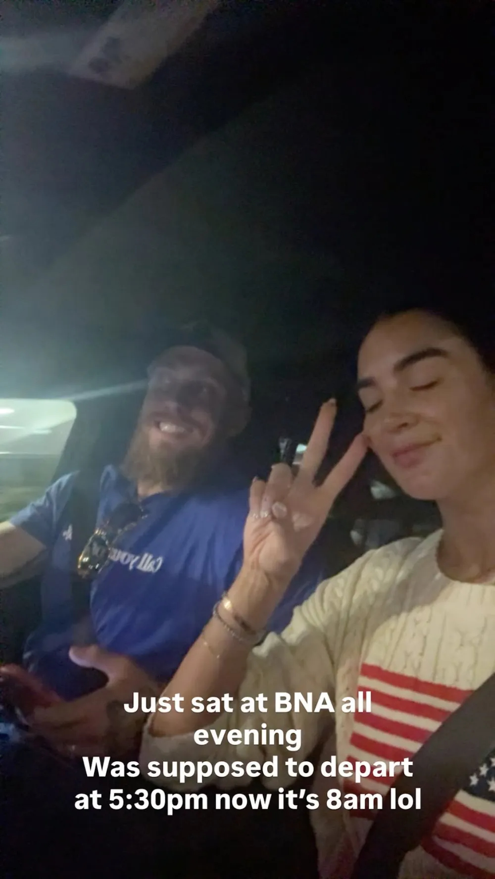 George Kittle and his wife smile in a car, depicting their travel delays at BNA.