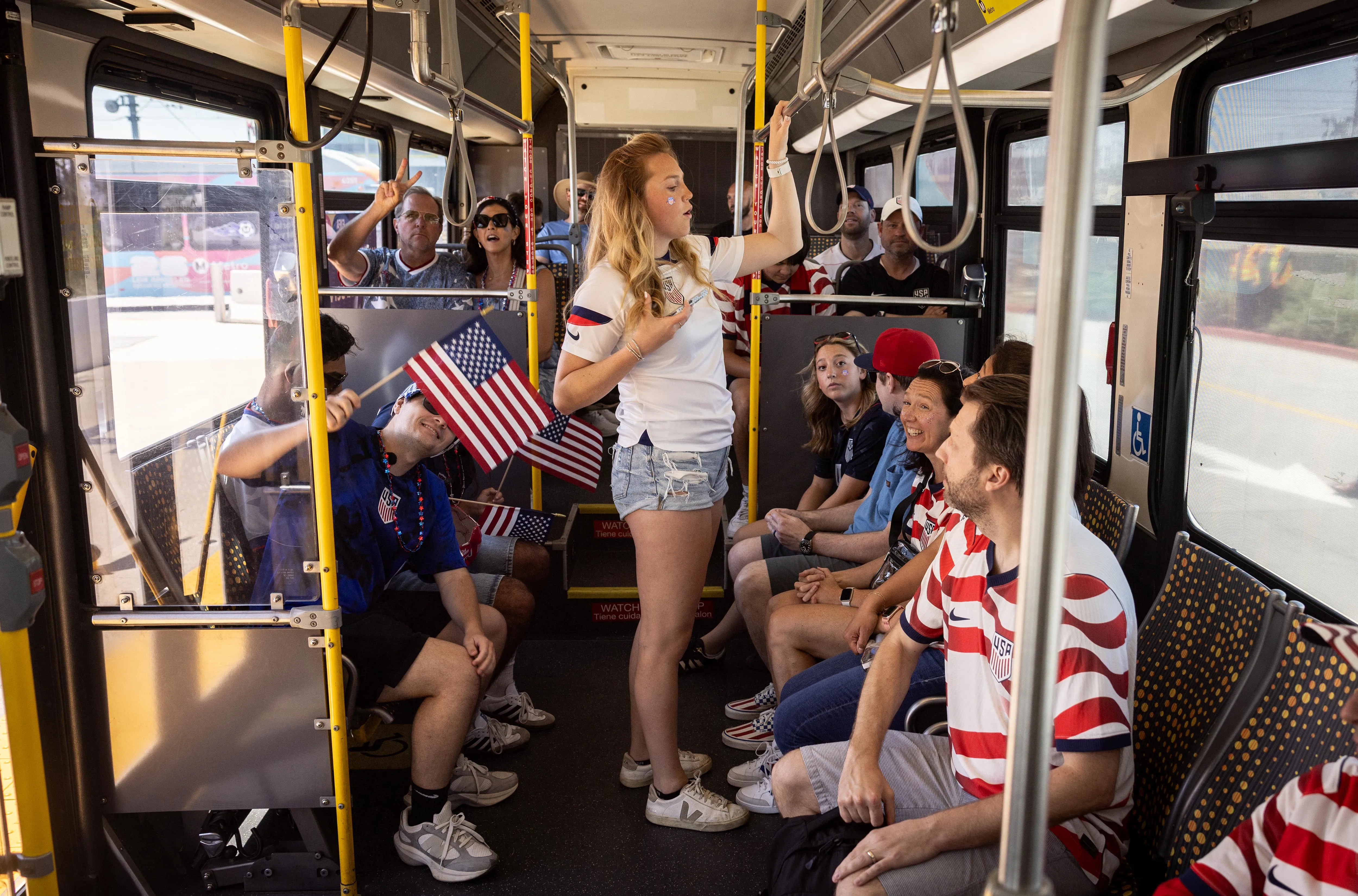 Fans wearing USA and Paraguay jerseys on a bus going to the World Cup