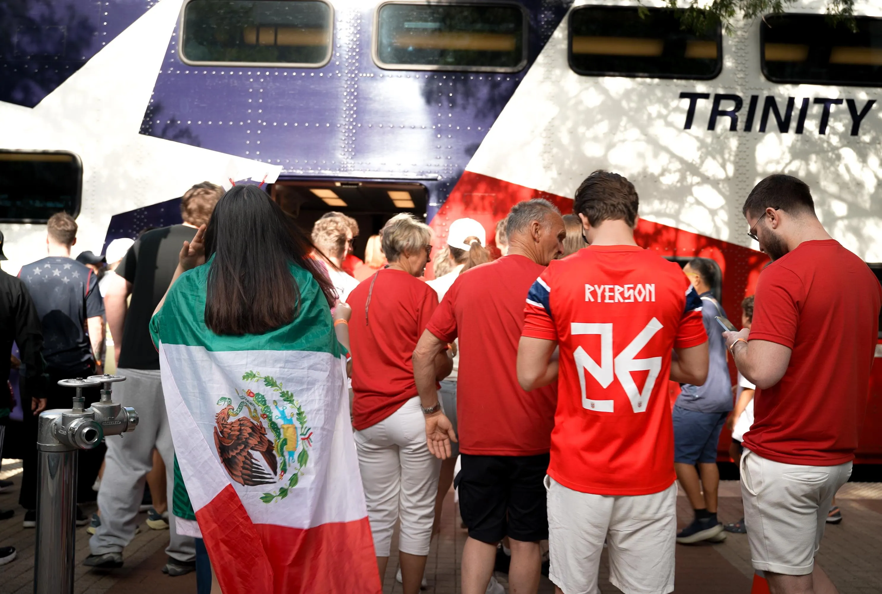 World Cup fans wait for a train with a Texas flag on it