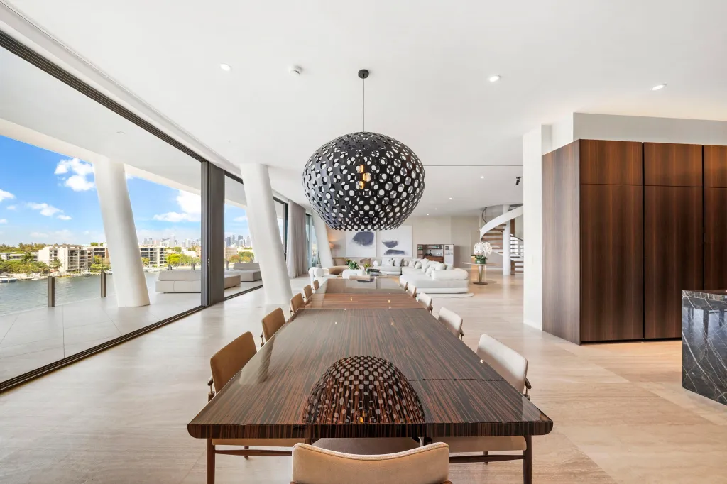 A formal dining room and retractable glass window walls that lead to the outdoor space
