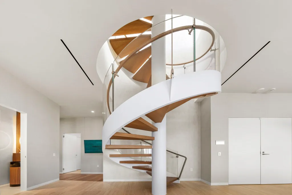 A sculptural staircase leads to a roofotop pool
