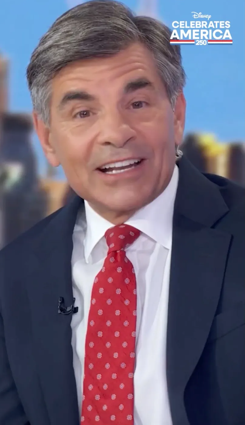 George Stephanopoulos wearing a suit and red tie.