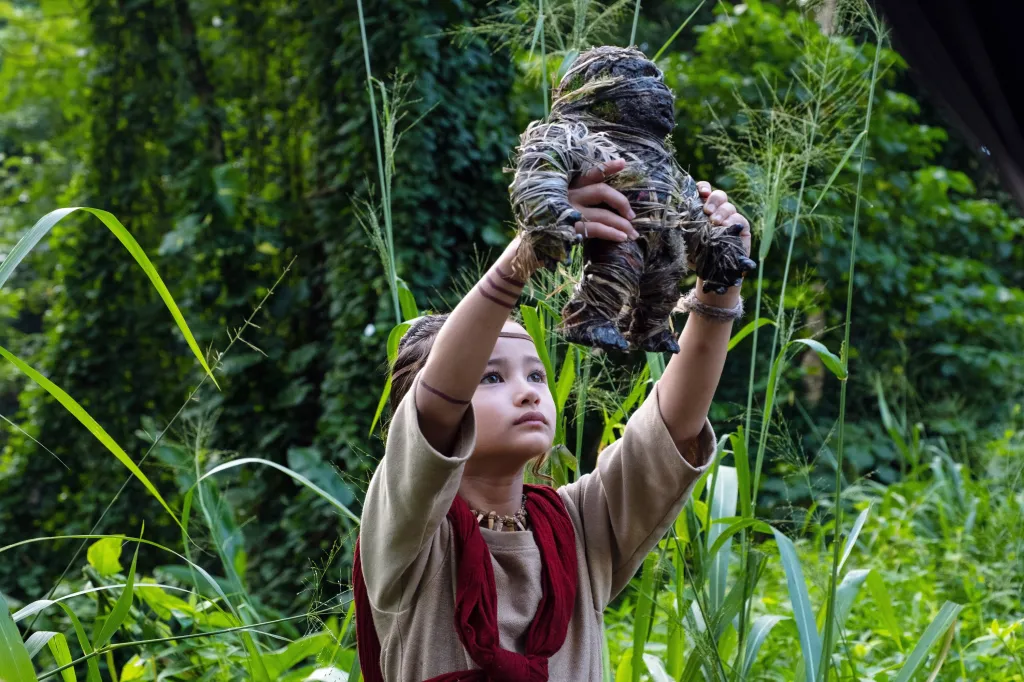 Kaylee Hottle holding a Kong doll in "Godzilla vs. Kong."