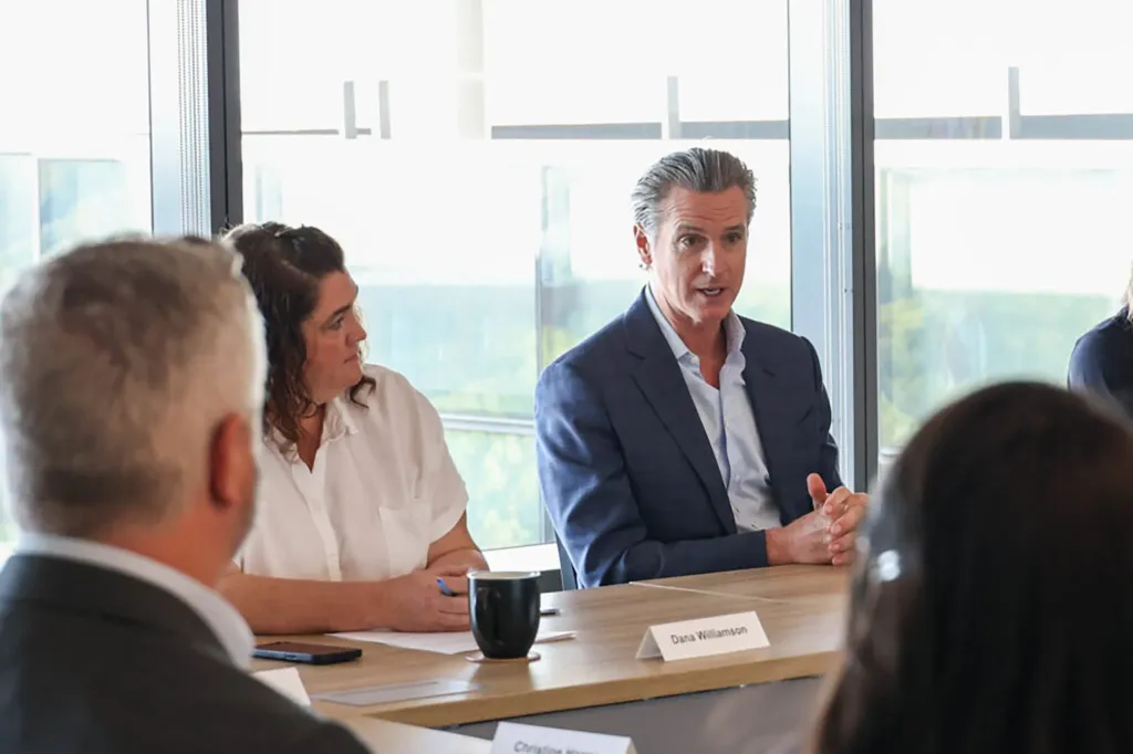 Gov. Gavin Newsom sitting with his former Chief of Staff Dana Williamson.