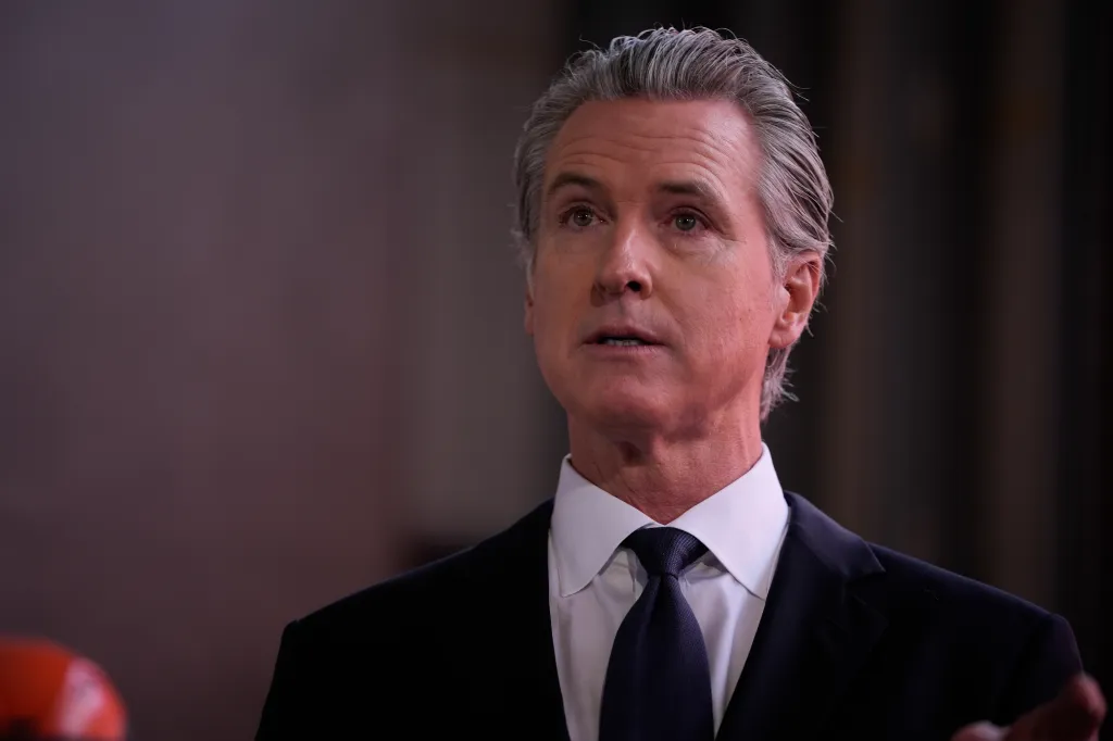 Close-up of Governor Gavin Newsom speaking at a press conference.