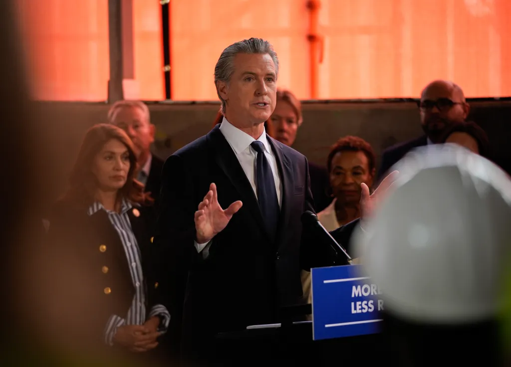 Governor Gavin Newsom speaking at a press conference on housing affordability reforms in Oakland.