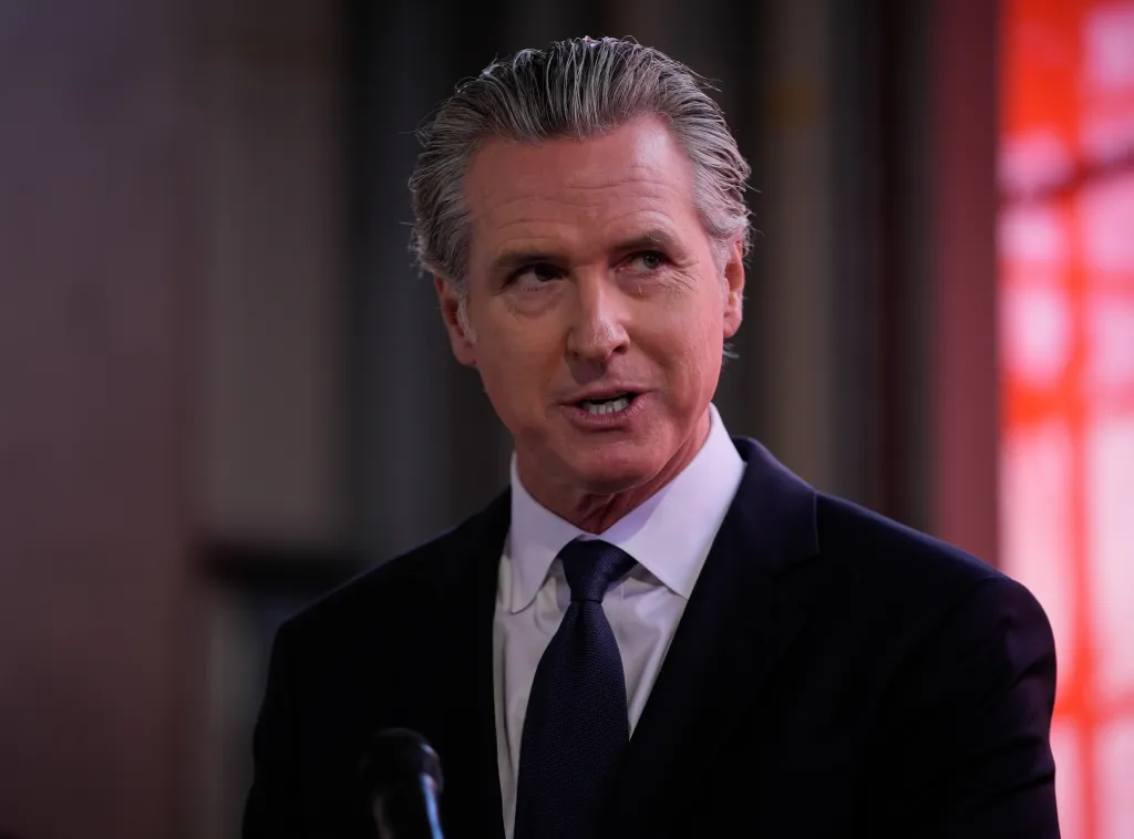 Governor Gavin Newsom speaking at a press conference in Oakland.
