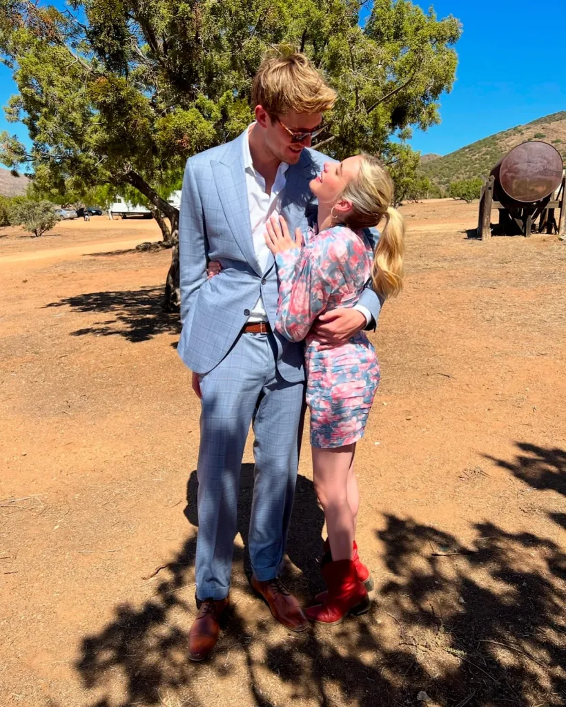 Emma Roberts and John Cody embracing and looking at each other.