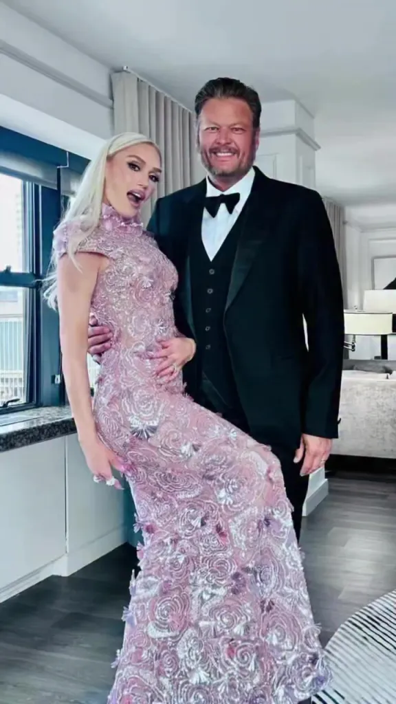 Gwen Stefani in a pink embellished gown with Blake Shelton in a black tuxedo.