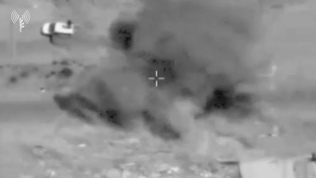 Thermal imagery showing an explosion in a Gaza street, near a vehicle.