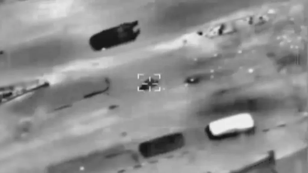 Thermal camera footage showing an aerial strike on a target.
