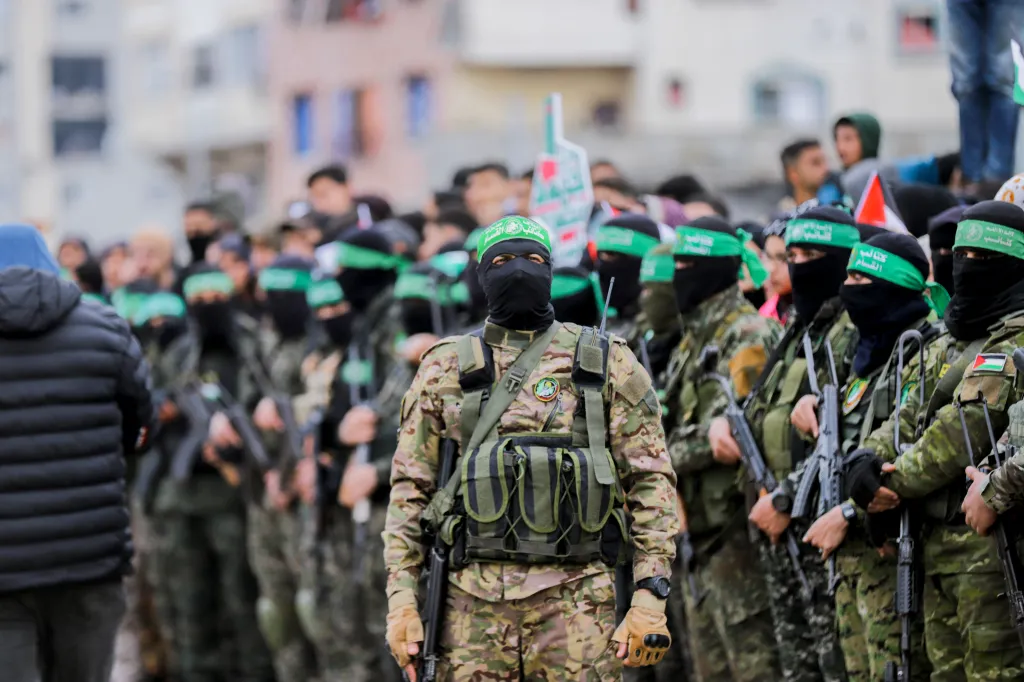 Hamas fighters gather at the site of the handing over of Israeli hostages at the Nuseirat refugee camp.