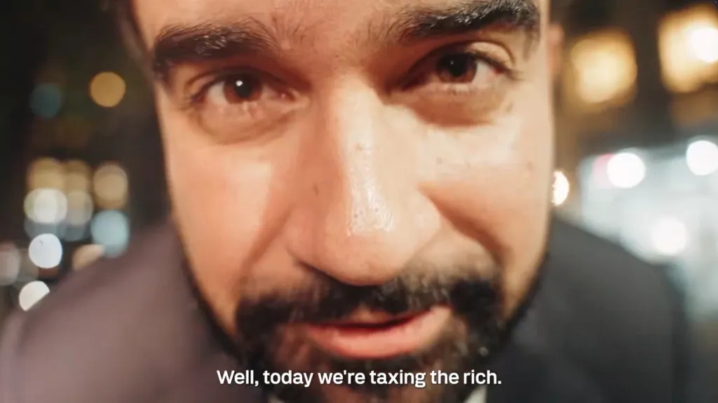 Close-up of Mayor Zohran Kwame Mamdani speaking, with the text 