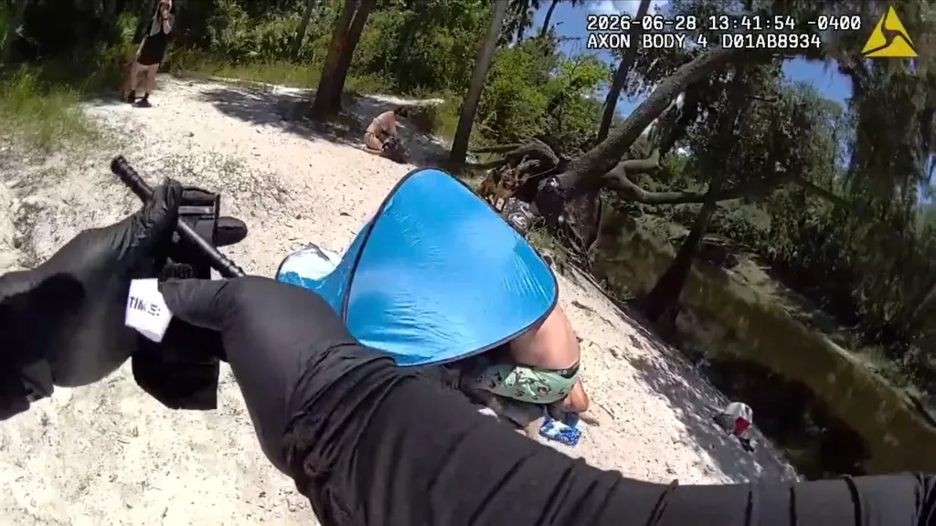 A photo of Clark's boyfriend hovered over under a blue tent trying to save Clark. 