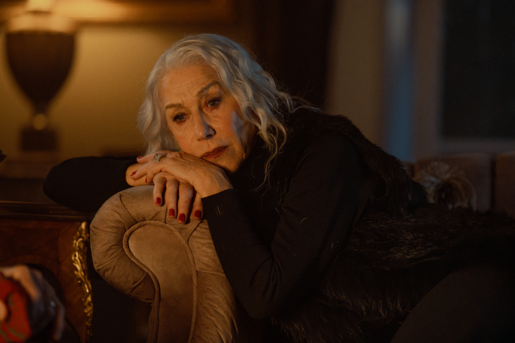 Helen Mirren as Maeve Harrigan with her head resting on her hands.