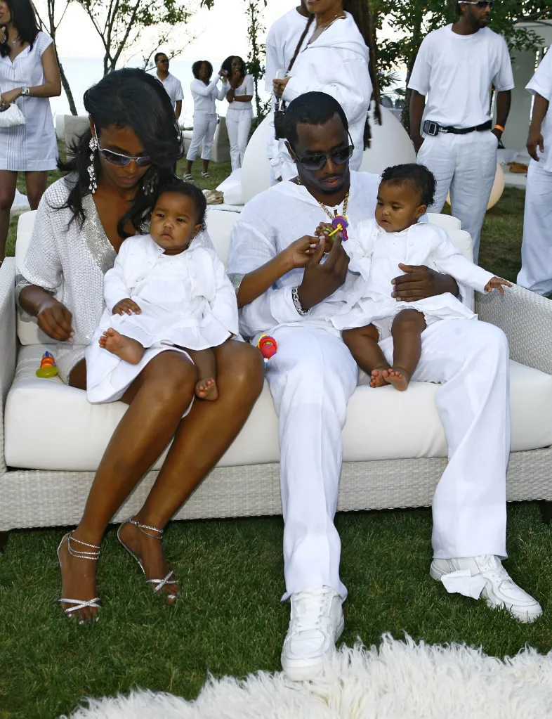 Sean "Diddy" Combs, Kim Porter, and their twin daughters at a white party.