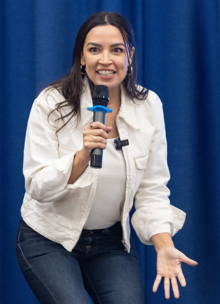 Rep. Alexandria Ocasio-Cortez speaking into a microphone.