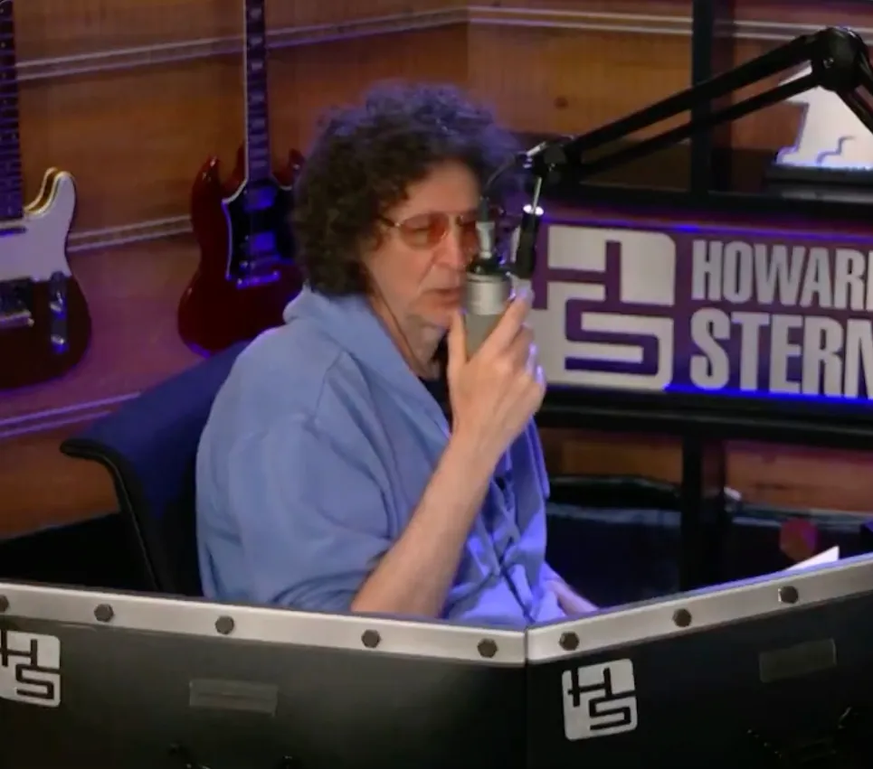 Howard Stern speaking into a microphone during his Sirius XM show.