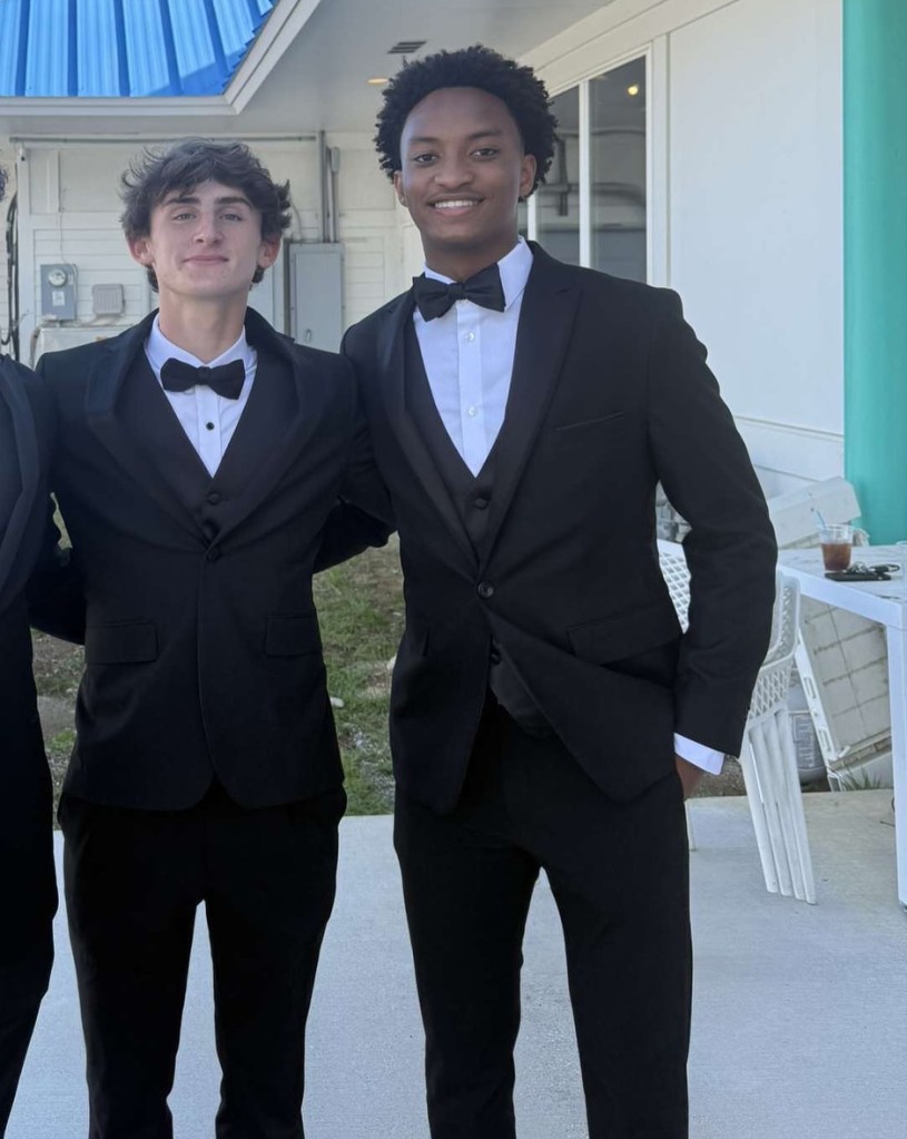Nolan Wells and Warren Hudson wearing black tuxedos.