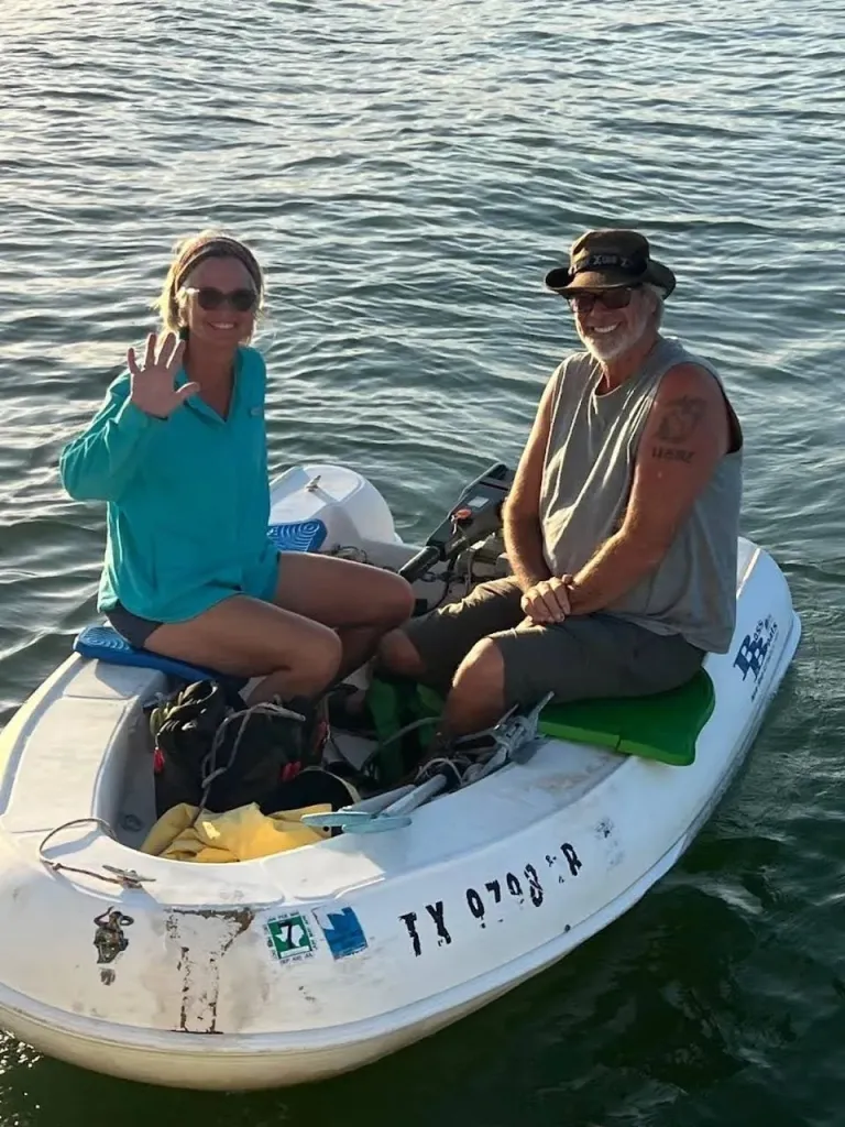 Lynette Hooker and her husband Brian Hooker sit in a small white boat.