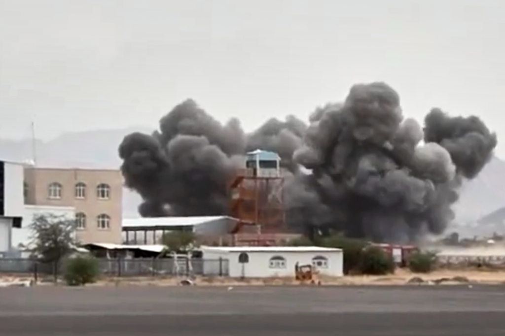 Smoke plumes rising from a building at Sanaa International Airport.