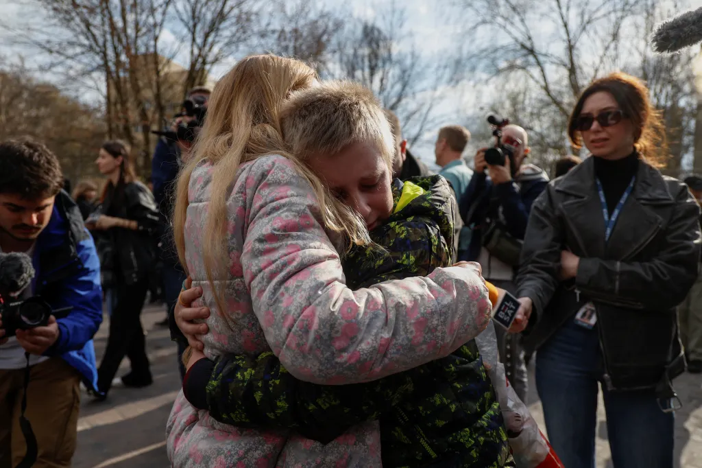 Iryna embraces her 13-year-old son Bohdan after his return from Russia to Kyiv, Ukraine.