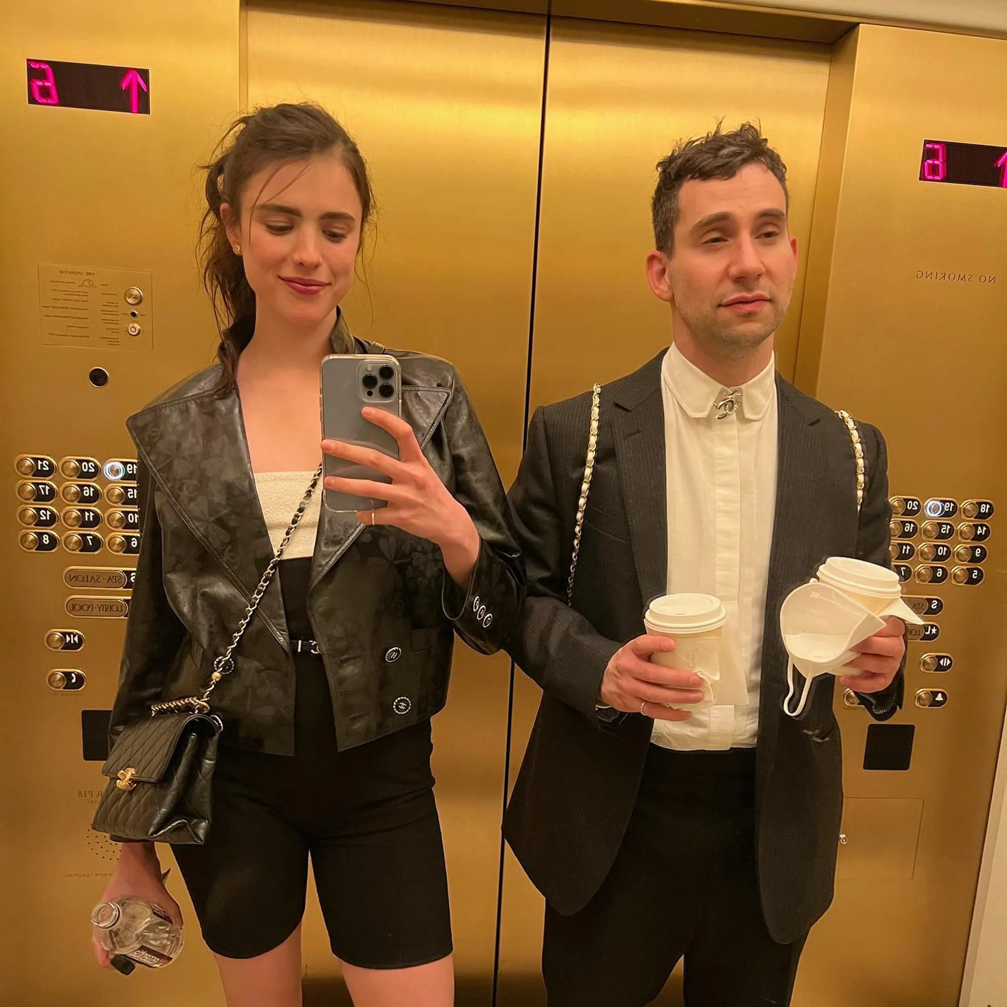 Margaret Qualley taking a selfie in a gold elevator with Jack Antonoff.
