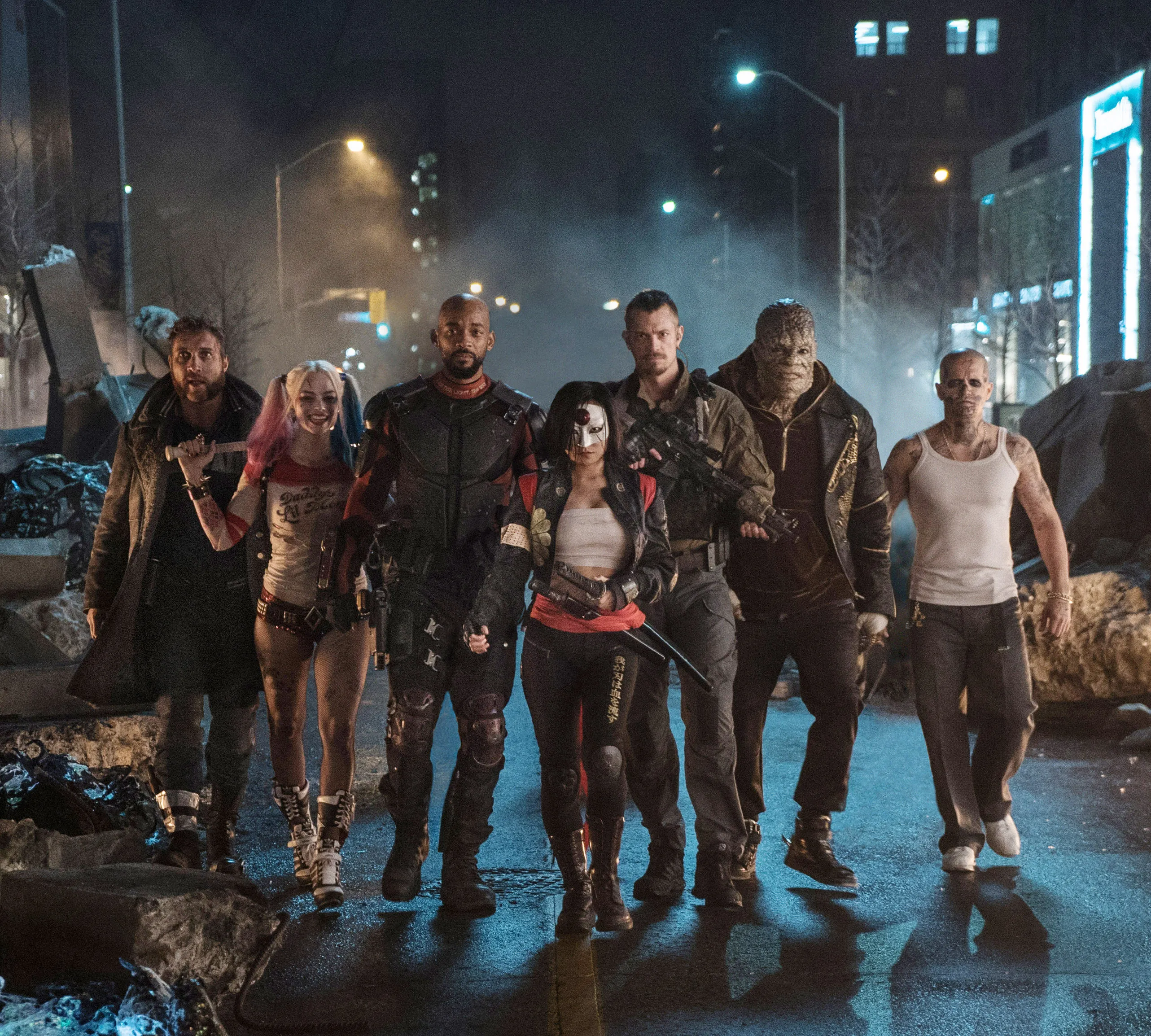 The cast of Suicide Squad, from left: Jai Courtney, Margot Robbie, Will Smith, Karen Fukuhara, Joel Kinnaman, Adewale Akinnuoye-Agbaje, Jay Hernandez, walking together at night.